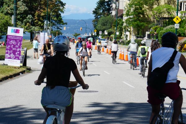 Several people ride along Vancouver's Beach Avenue Bikeway.