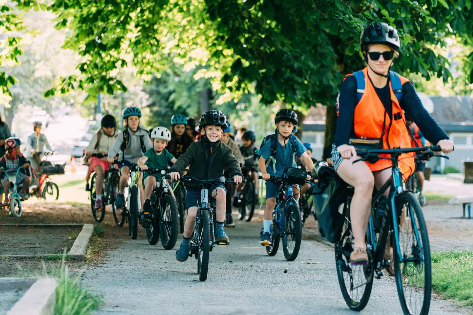 An instructor leads students on a bike bus.